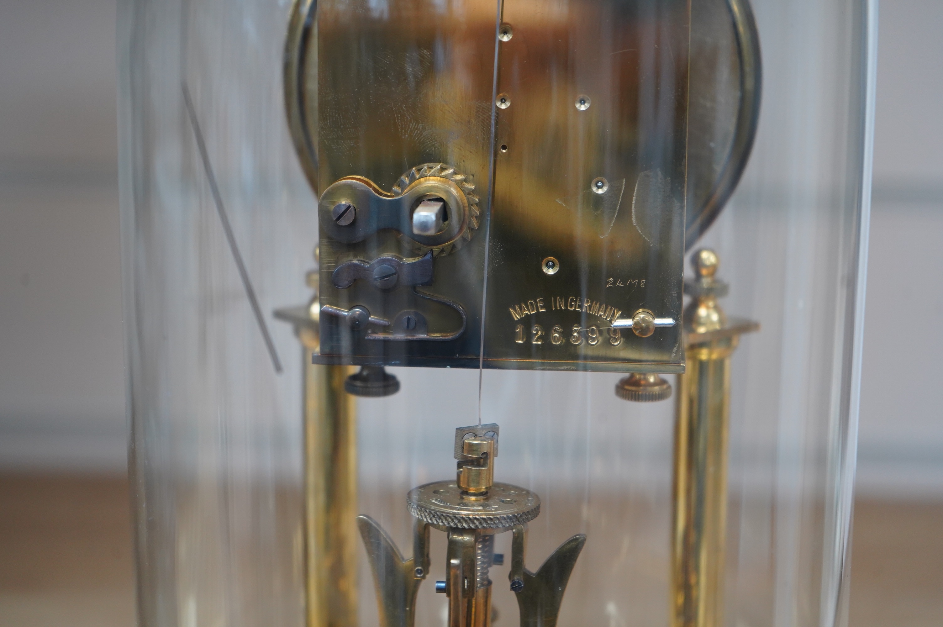 A late 19th century German 400 day torsion clock under dome, 26cm. Condition - fair to good. Not tested